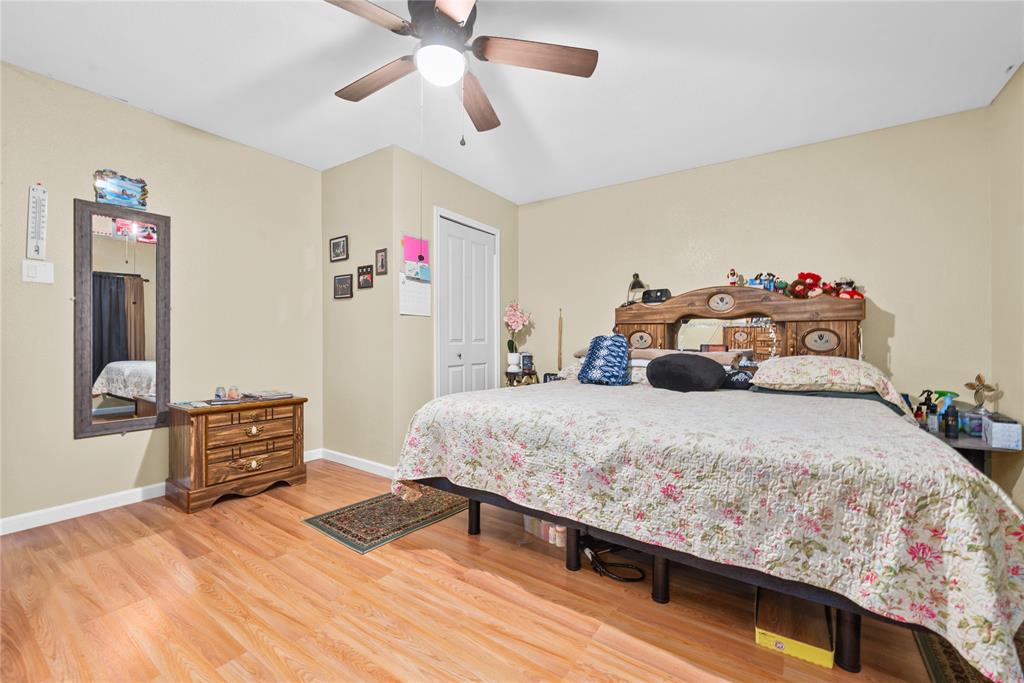 447 Masthead Road Gun Barrel City, TX 75156 - Photo 13 of 27 a bedroom with a bed and wooden floor