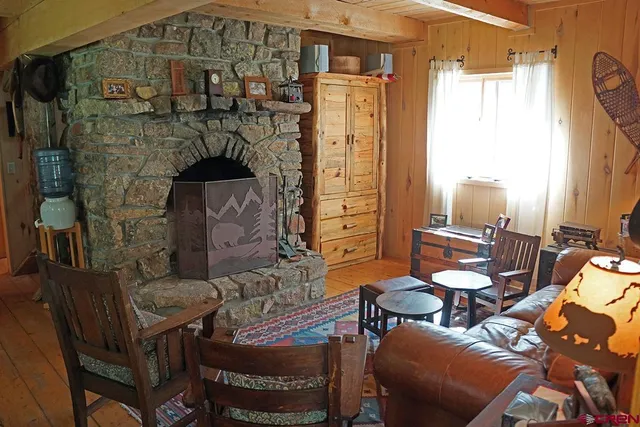 a living room with furniture a window and wooden floor