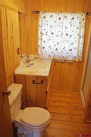 a bedroom with a bed dresser and a window