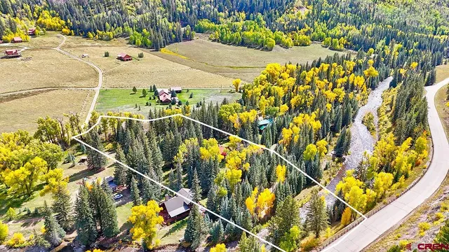 a view of a yard with wooden fence