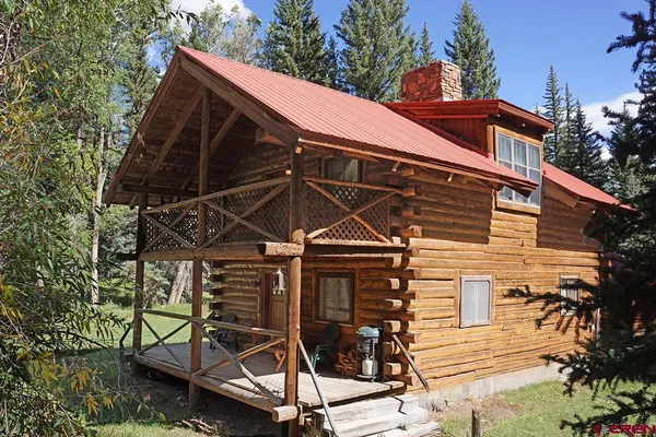 a view of a balcony with two chairs and a table