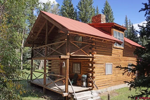 a view of a balcony with two chairs and a table