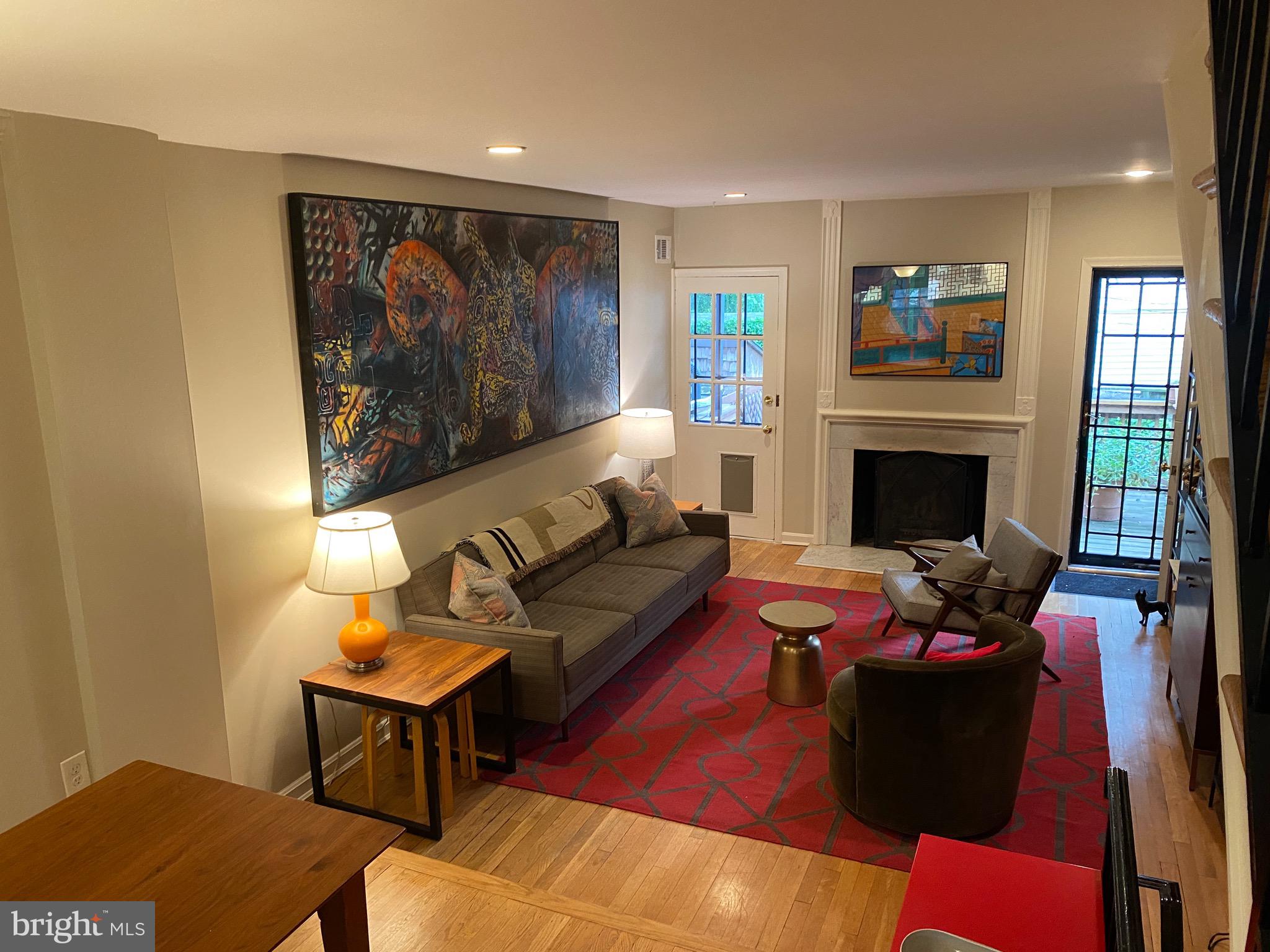 339 11th Street Southeast Washington, DC 20003 - Photo 27 of 39 a living room with furniture a fireplace and a flat screen tv