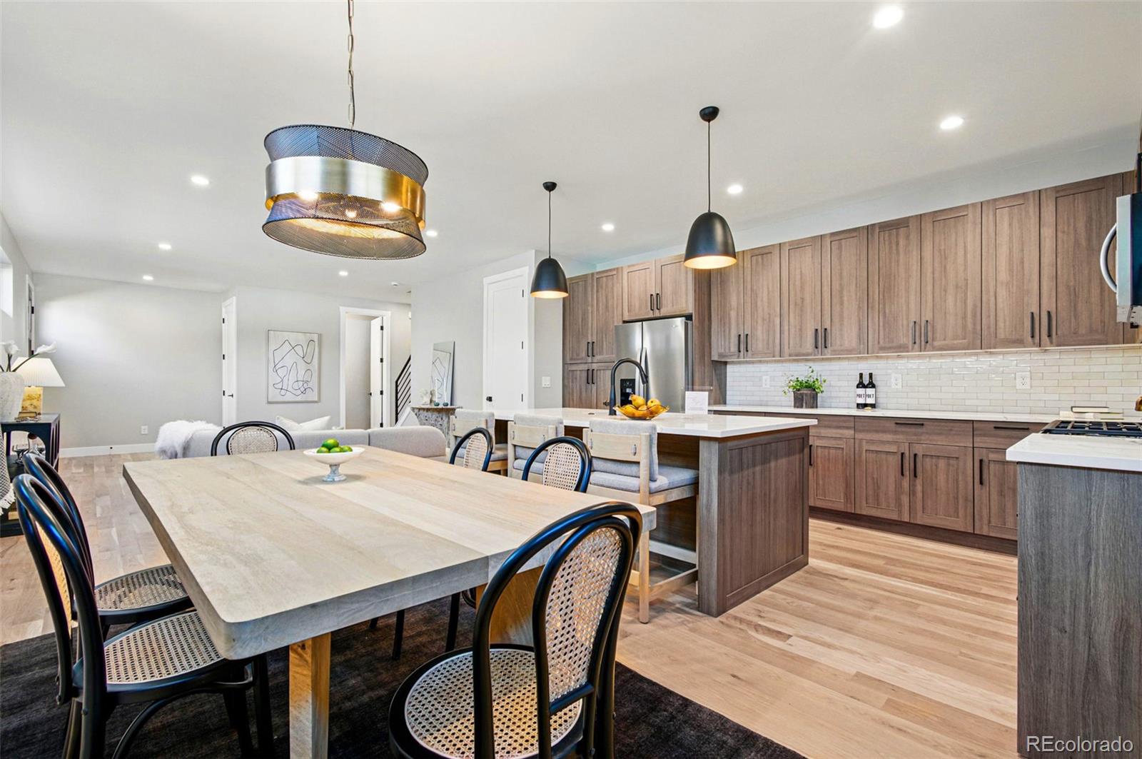 4121 Tejon Street Denver, CO 80211 - Photo 11 of 38 a kitchen with a dining table chairs sink and cabinets