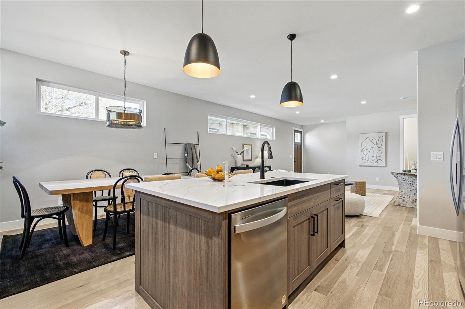 4121 Tejon Street Denver, CO 80211 - Photo 14 of 38 a kitchen that has a table chairs and a wooden floor