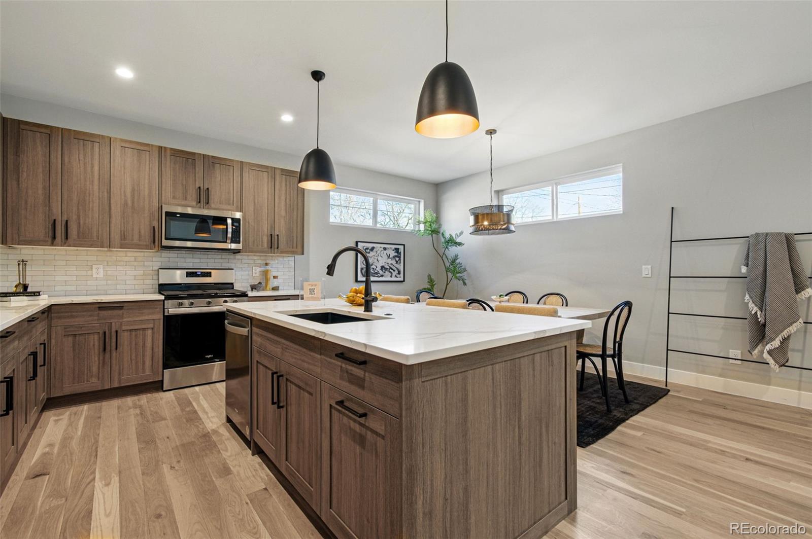 4121 Tejon Street Denver, CO 80211 - Photo 16 of 38 a kitchen with a stove and a sink