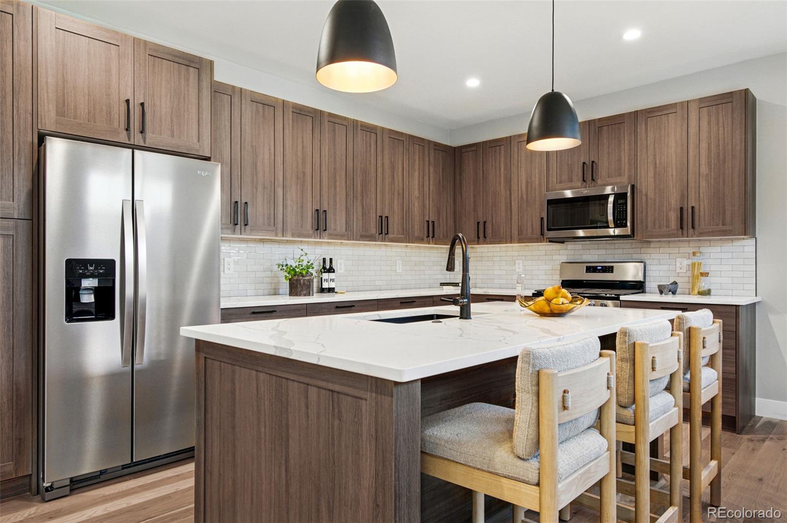 4121 Tejon Street Denver, CO 80211 - Photo 18 of 38 a kitchen with a refrigerator a stove a microwave and wooden cabinets