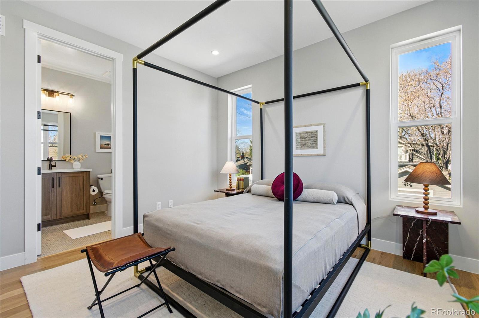 4121 Tejon Street Denver, CO 80211 - Photo 21 of 38 a bedroom with a bed and dresser with mirror