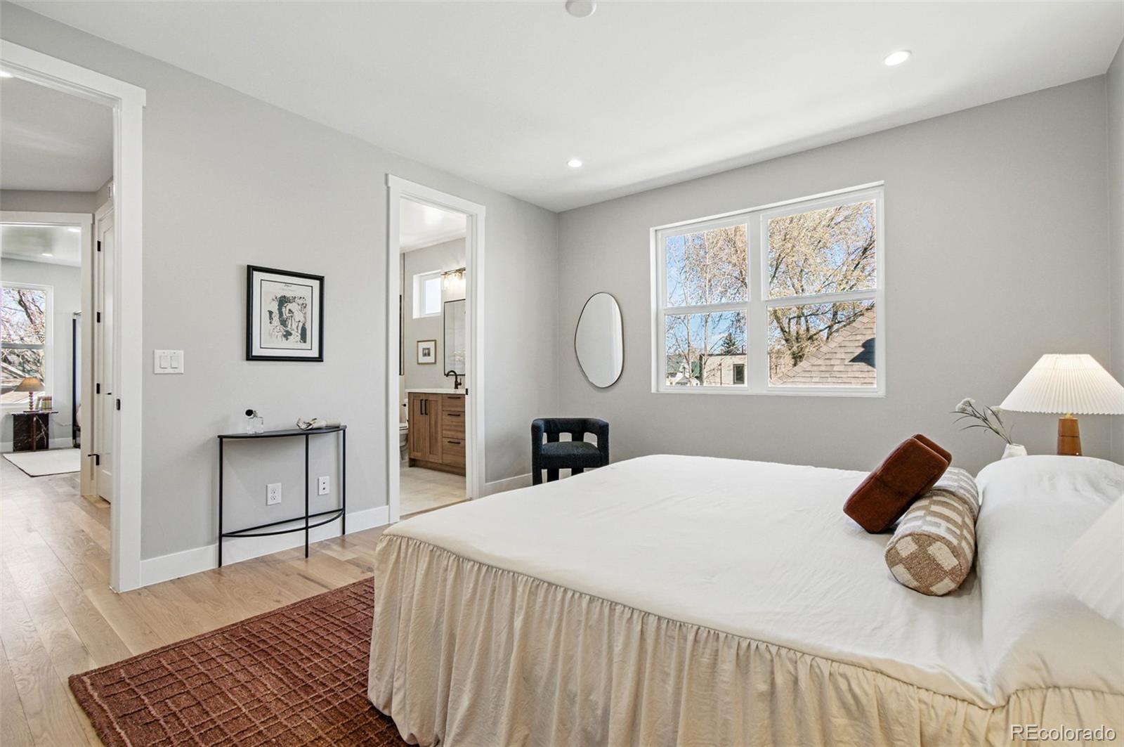 4121 Tejon Street Denver, CO 80211 - Photo 28 of 38 a bedroom with a bed and a painting on the wall