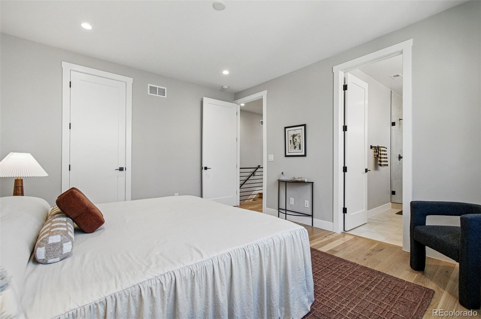 4121 Tejon Street Denver, CO 80211 - Photo 29 of 38 a bedroom with a bed and a lamp