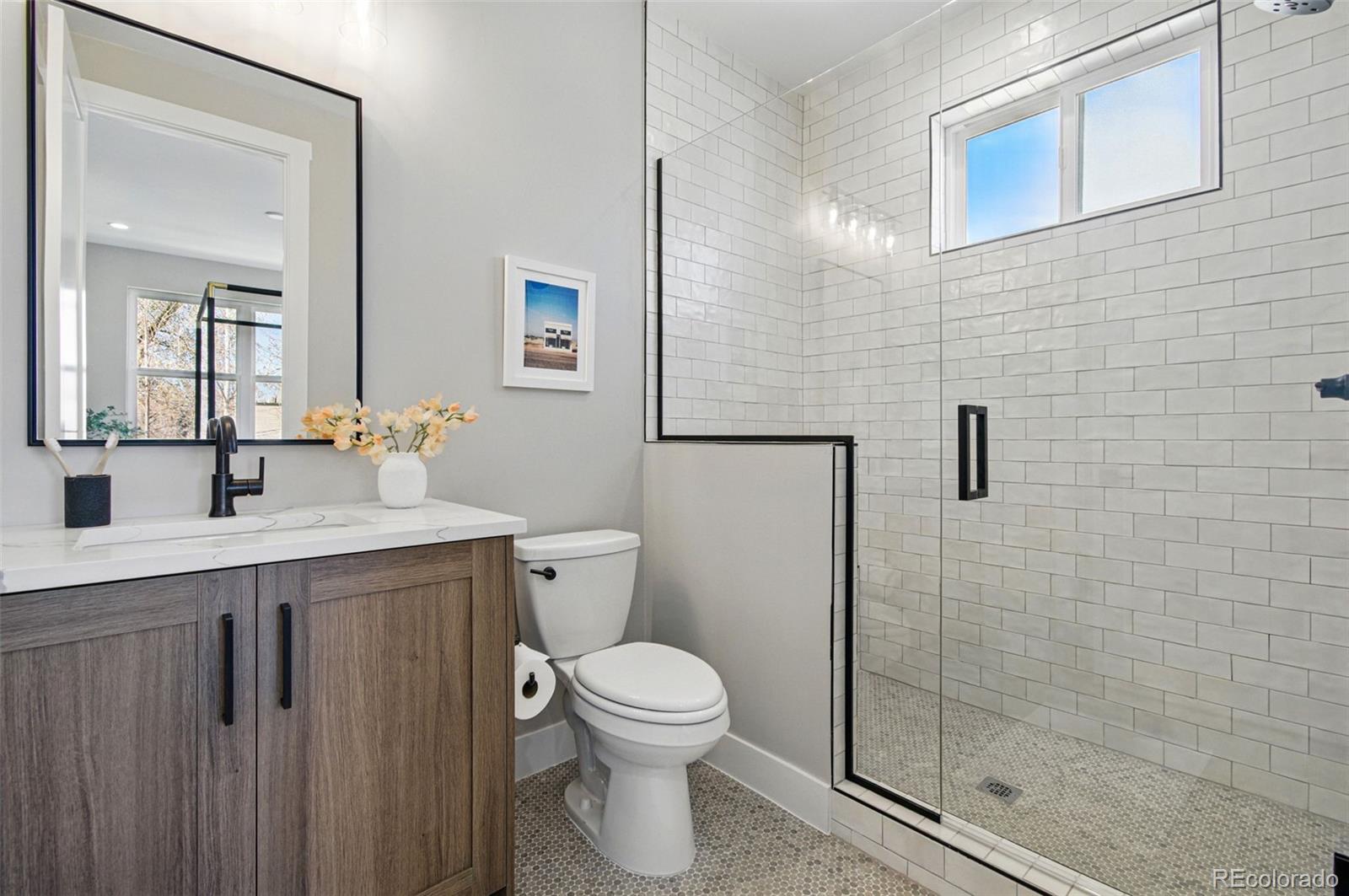 4121 Tejon Street Denver, CO 80211 - Photo 30 of 38 a bathroom with a toilet sink vanity and mirror