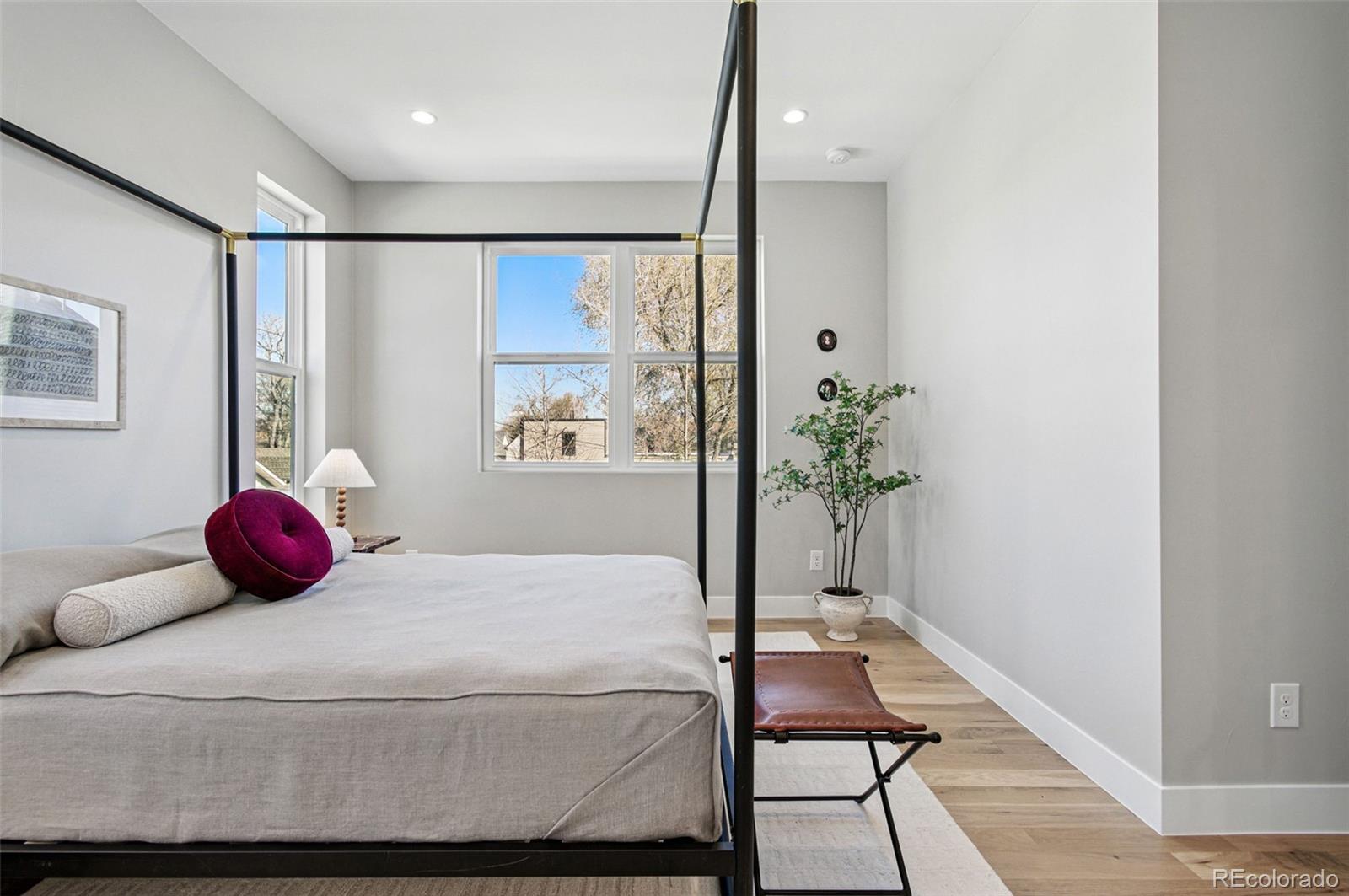 4121 Tejon Street Denver, CO 80211 - Photo 4 of 38 a bedroom with a bed and a potted plant