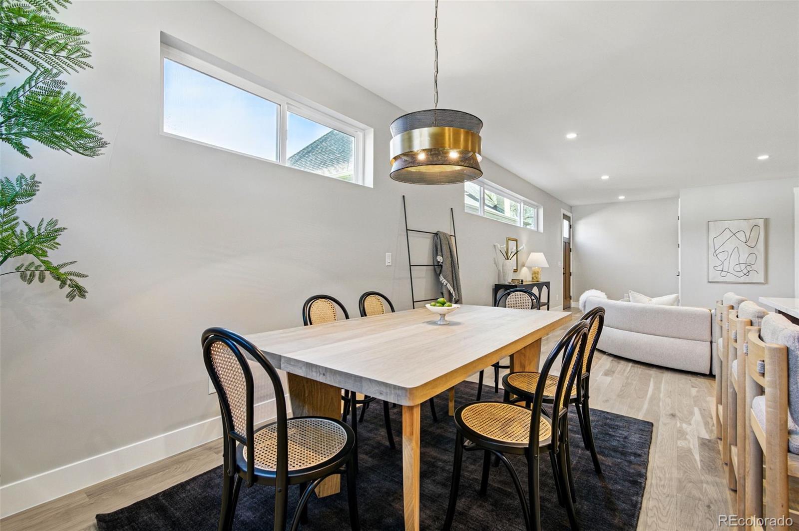 4121 Tejon Street Denver, CO 80211 - Photo 10 of 38 a view of a dining room and livingroom with furniture wooden floor a chandelier