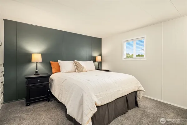 a bedroom with a bed and a lamp