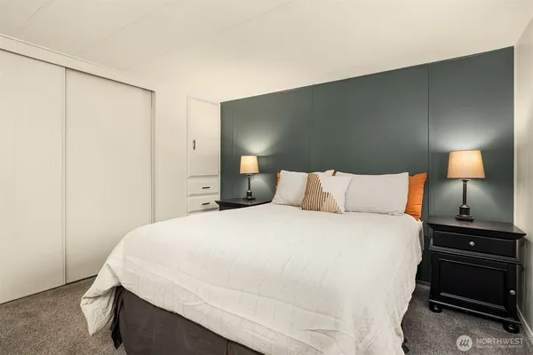 a bedroom with a bed and a night stand