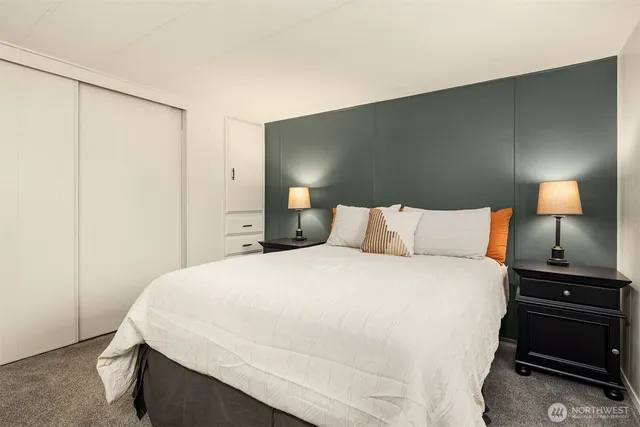 a bedroom with a bed and a night stand