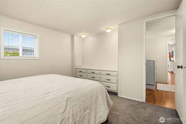 a spacious bedroom with a bed and a cabinets