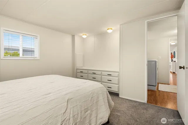 a spacious bedroom with a bed and a cabinets