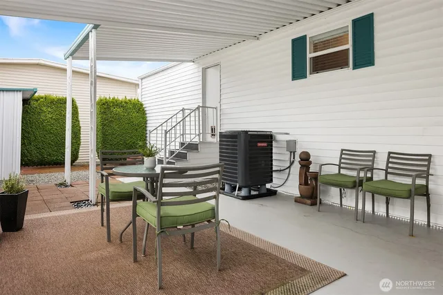 a view of a patio with a table and chairs and potted plants