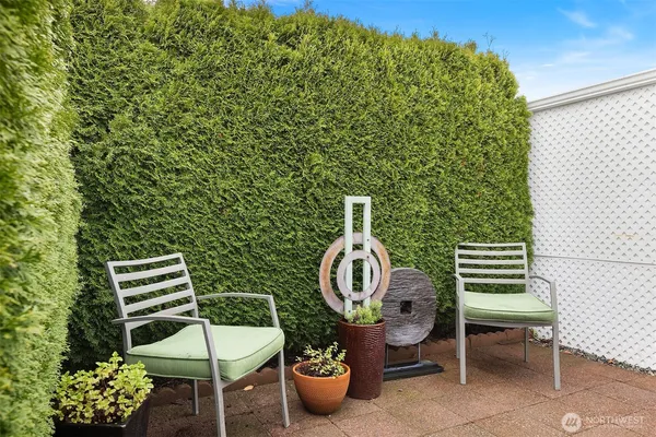 a backyard of a house with barbeque oven table and chairs