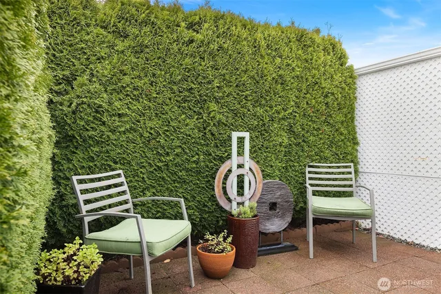 a backyard of a house with barbeque oven table and chairs