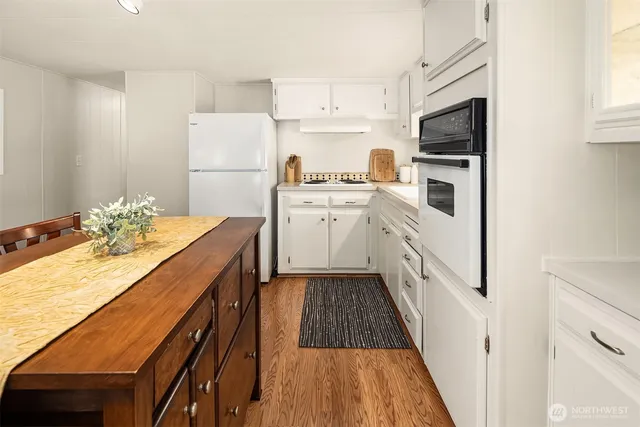 a kitchen with white cabinets sink and white appliances