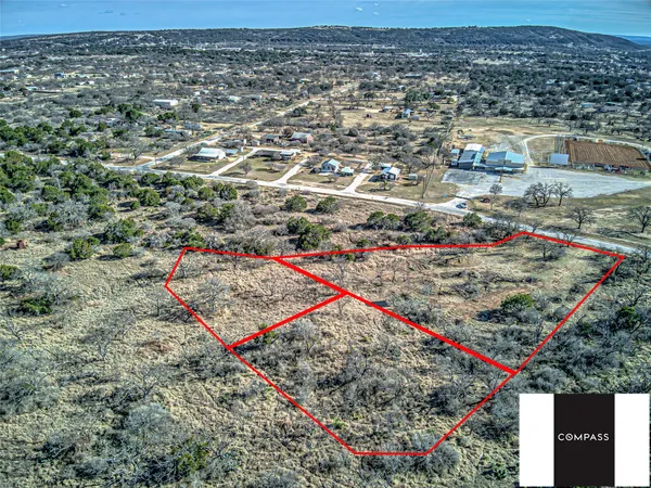 an aerial view of a houses with a yard
