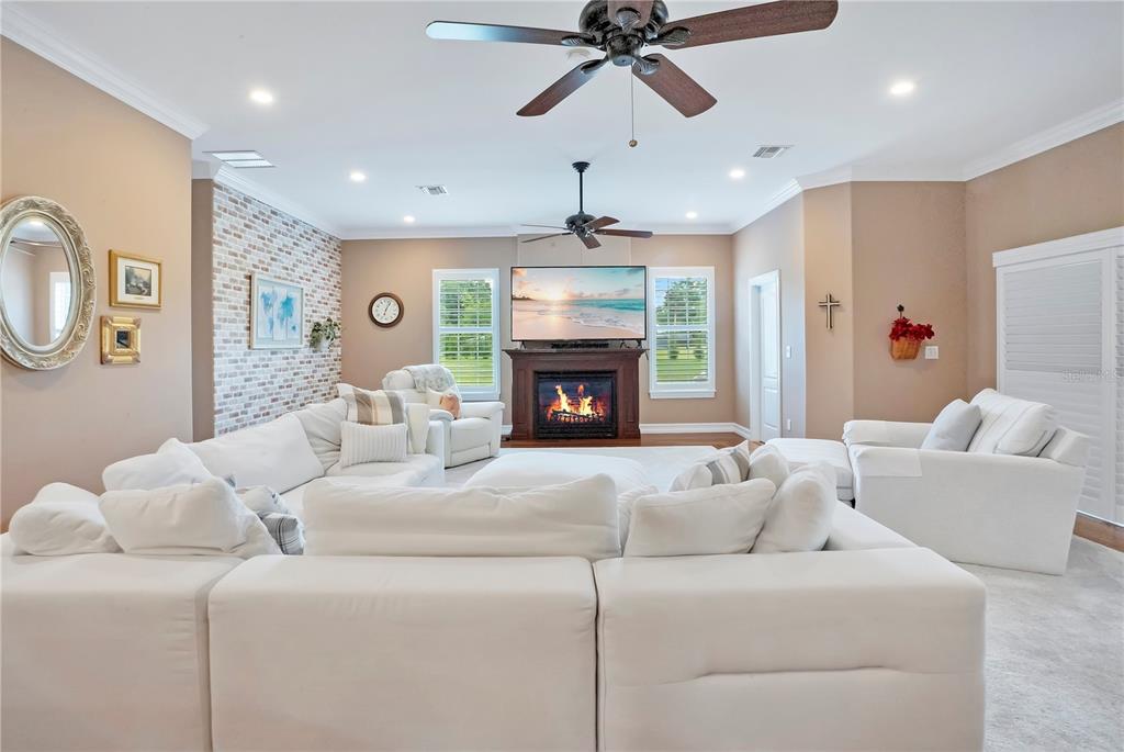 5785 Gilliam Road Orlando, FL 32818 - Photo 32 of 100 a living room with furniture and a fireplace