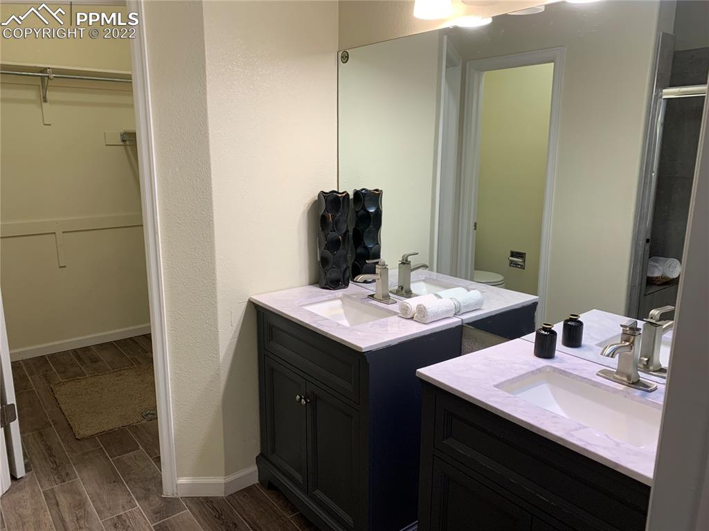 924 Samuel Point Colorado Springs, CO 80906 - Photo 18 of 22 a bathroom with a sink and a mirror