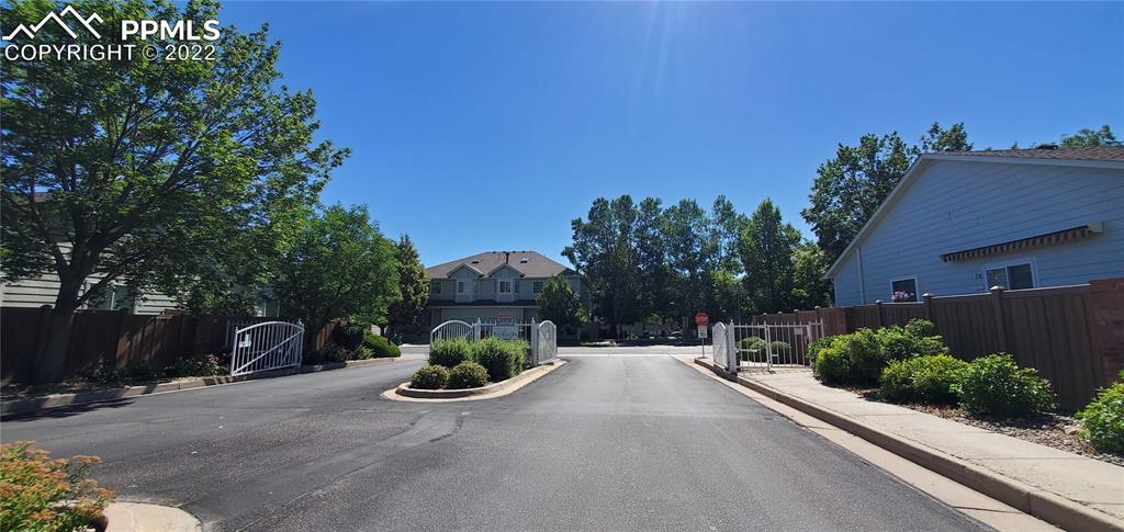 924 Samuel Point Colorado Springs, CO 80906 - Photo 4 of 22 a view of a street with potted plants and a large tree