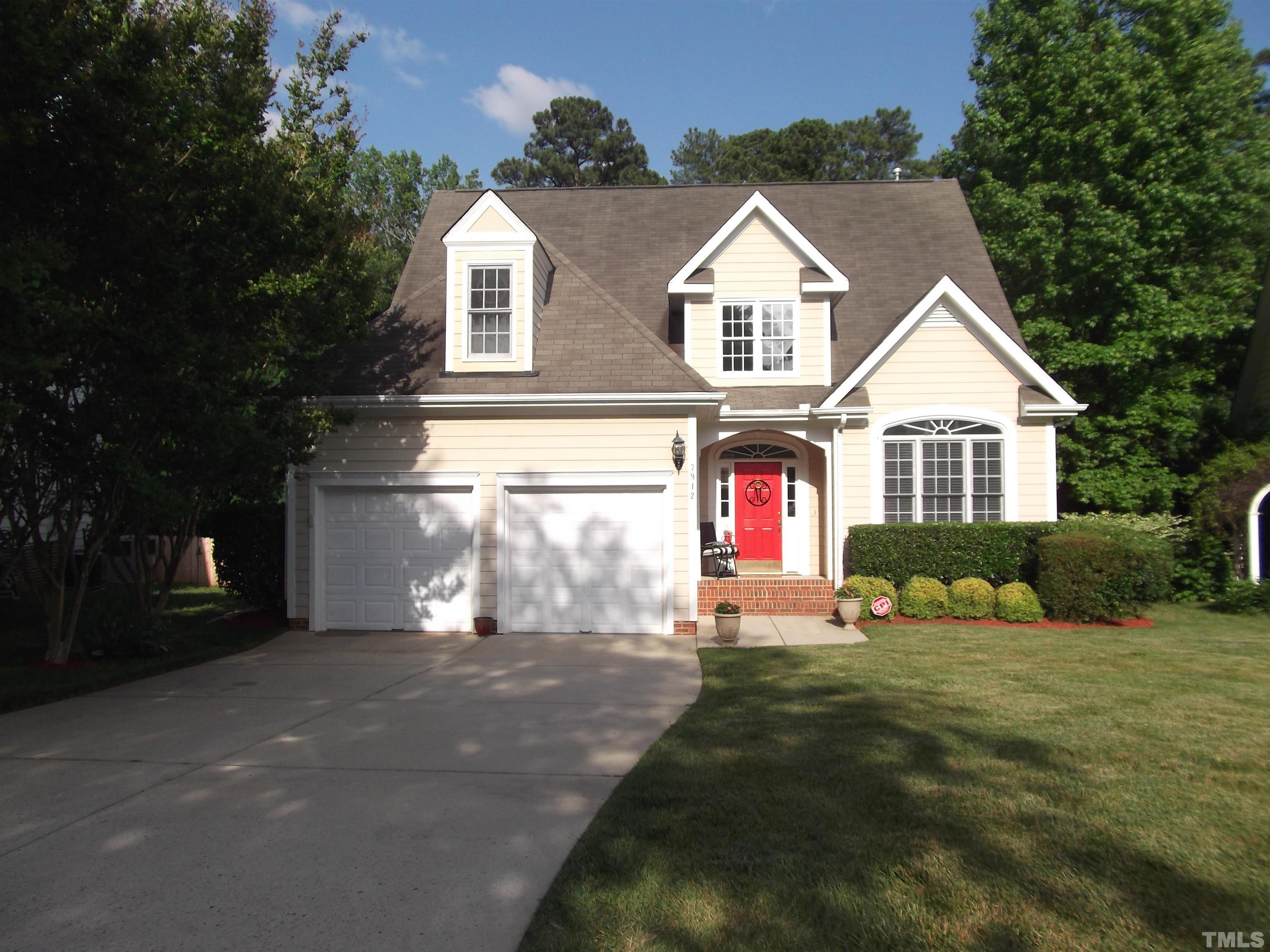 7912 Milltrace Run Raleigh, NC 27615 - Photo 1 of 36 a front view of a house with a yard and garage