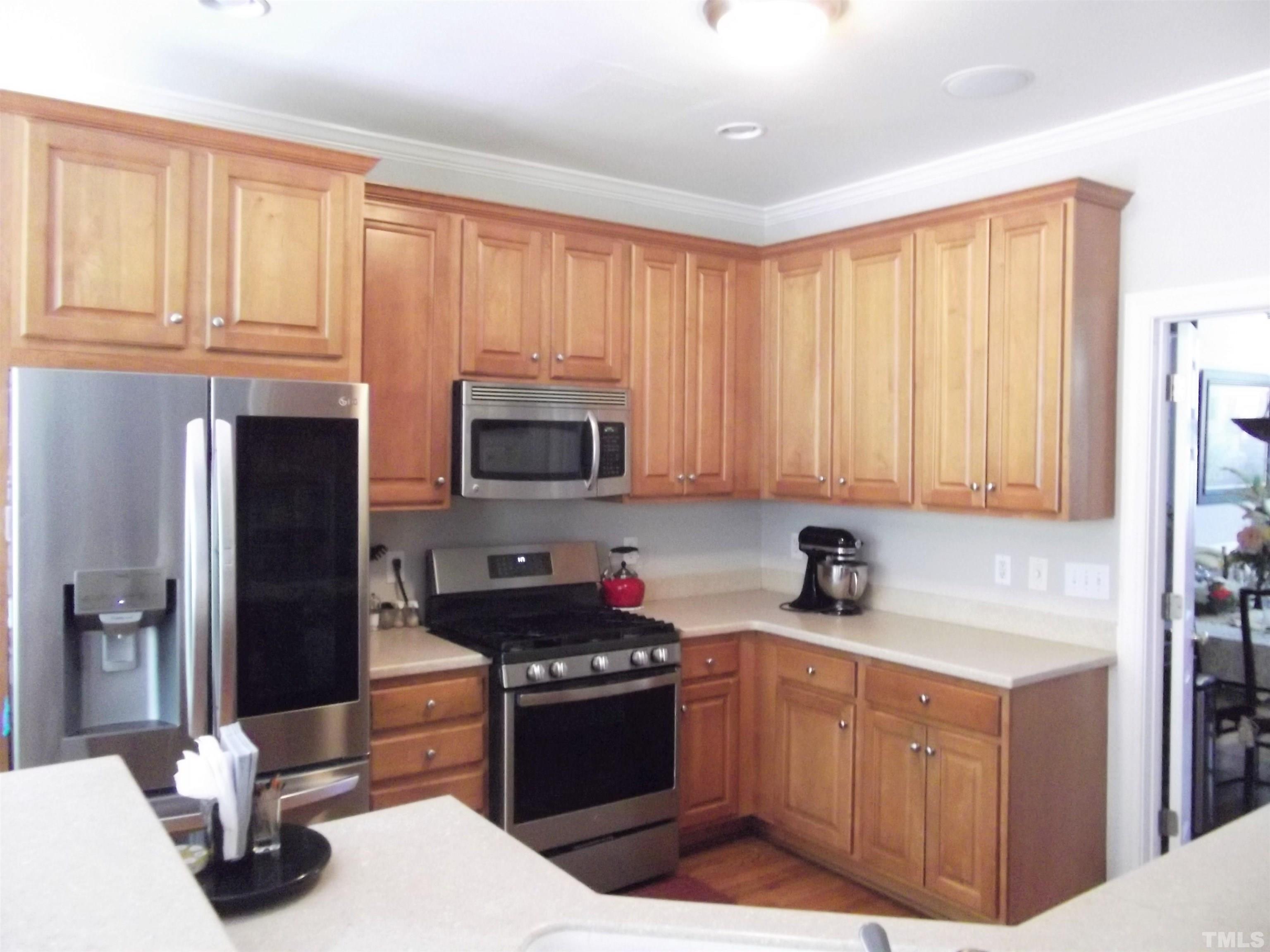 7912 Milltrace Run Raleigh, NC 27615 - Photo 12 of 36 a kitchen with stainless steel appliances granite countertop a refrigerator sink and cabinets