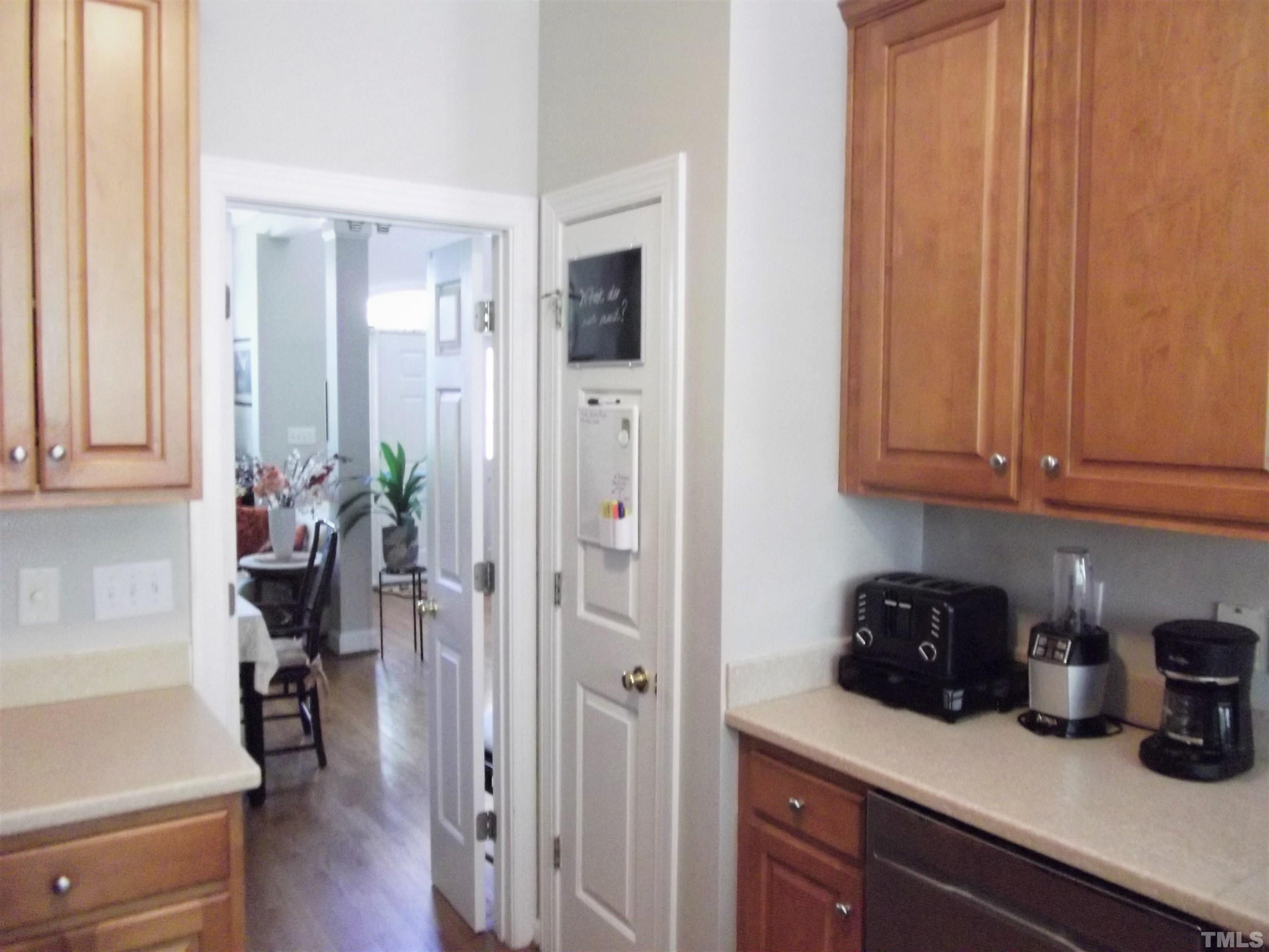 7912 Milltrace Run Raleigh, NC 27615 - Photo 14 of 36 a kitchen with a refrigerator and cabinets