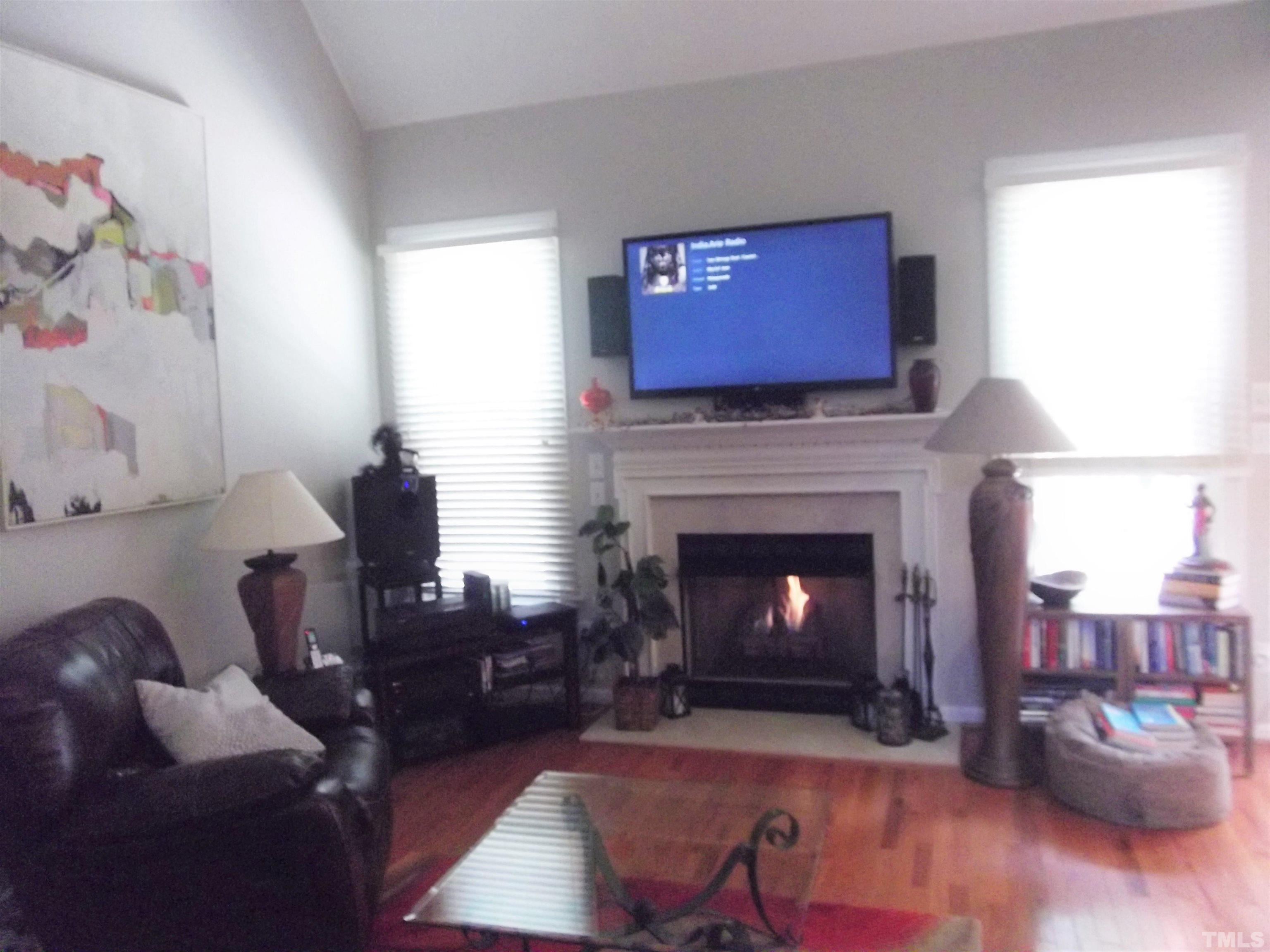 7912 Milltrace Run Raleigh, NC 27615 - Photo 18 of 36 a living room with furniture and a fireplace
