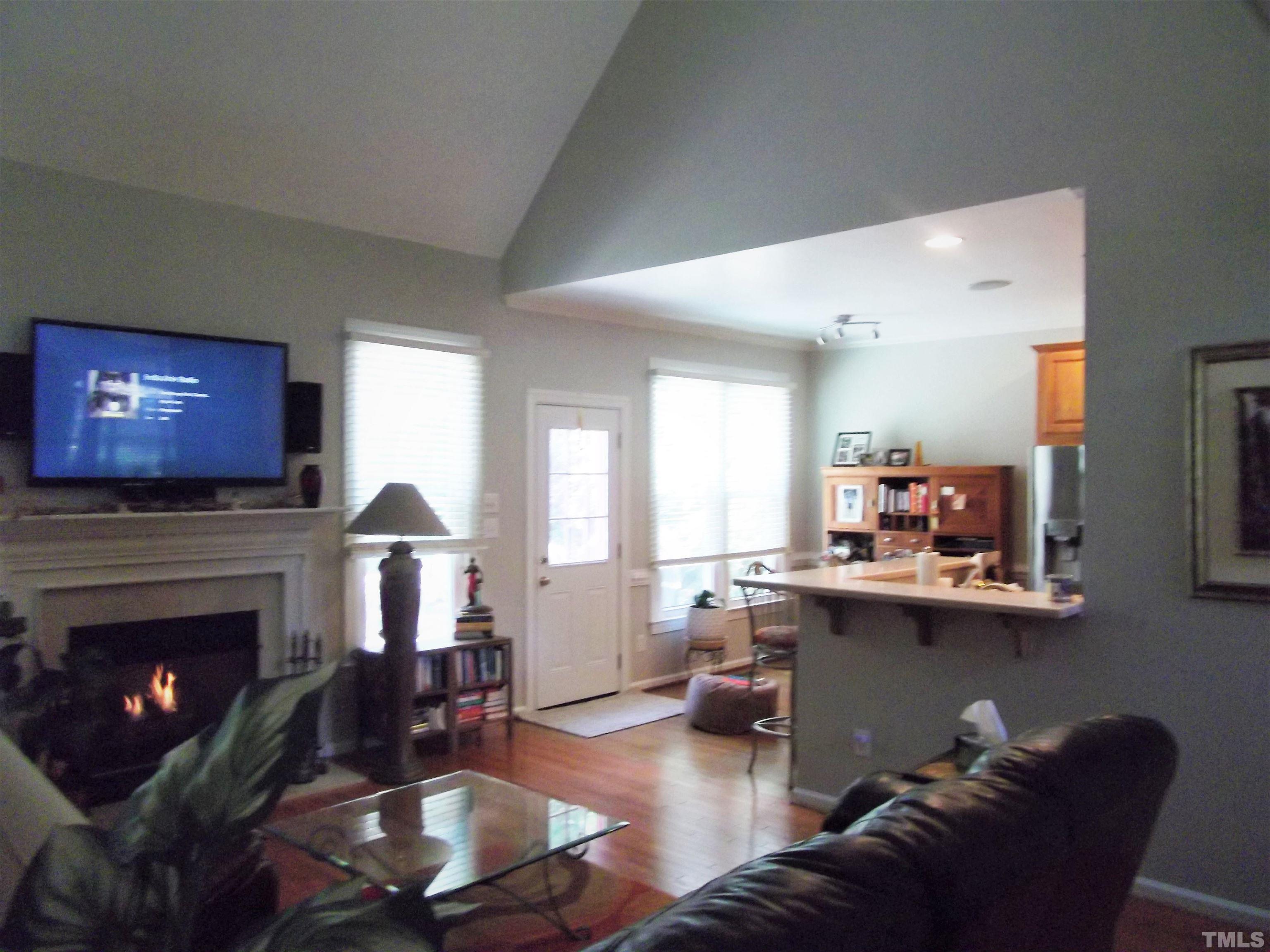 7912 Milltrace Run Raleigh, NC 27615 - Photo 20 of 36 a living room with furniture a fireplace and window