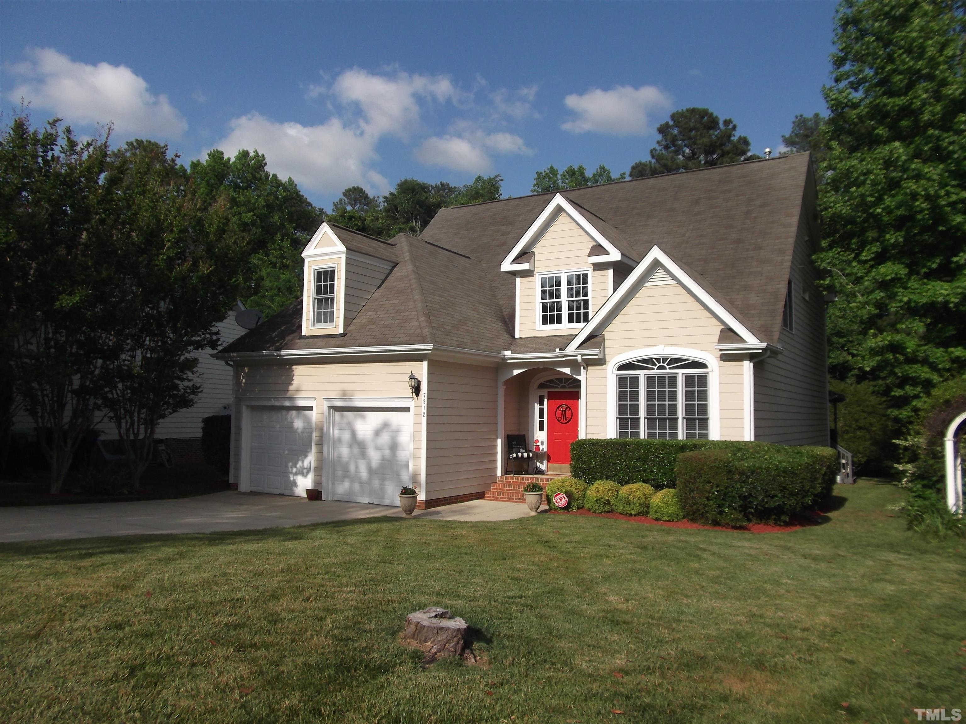 7912 Milltrace Run Raleigh, NC 27615 - Photo 2 of 36 a front view of a house with a yard and garage