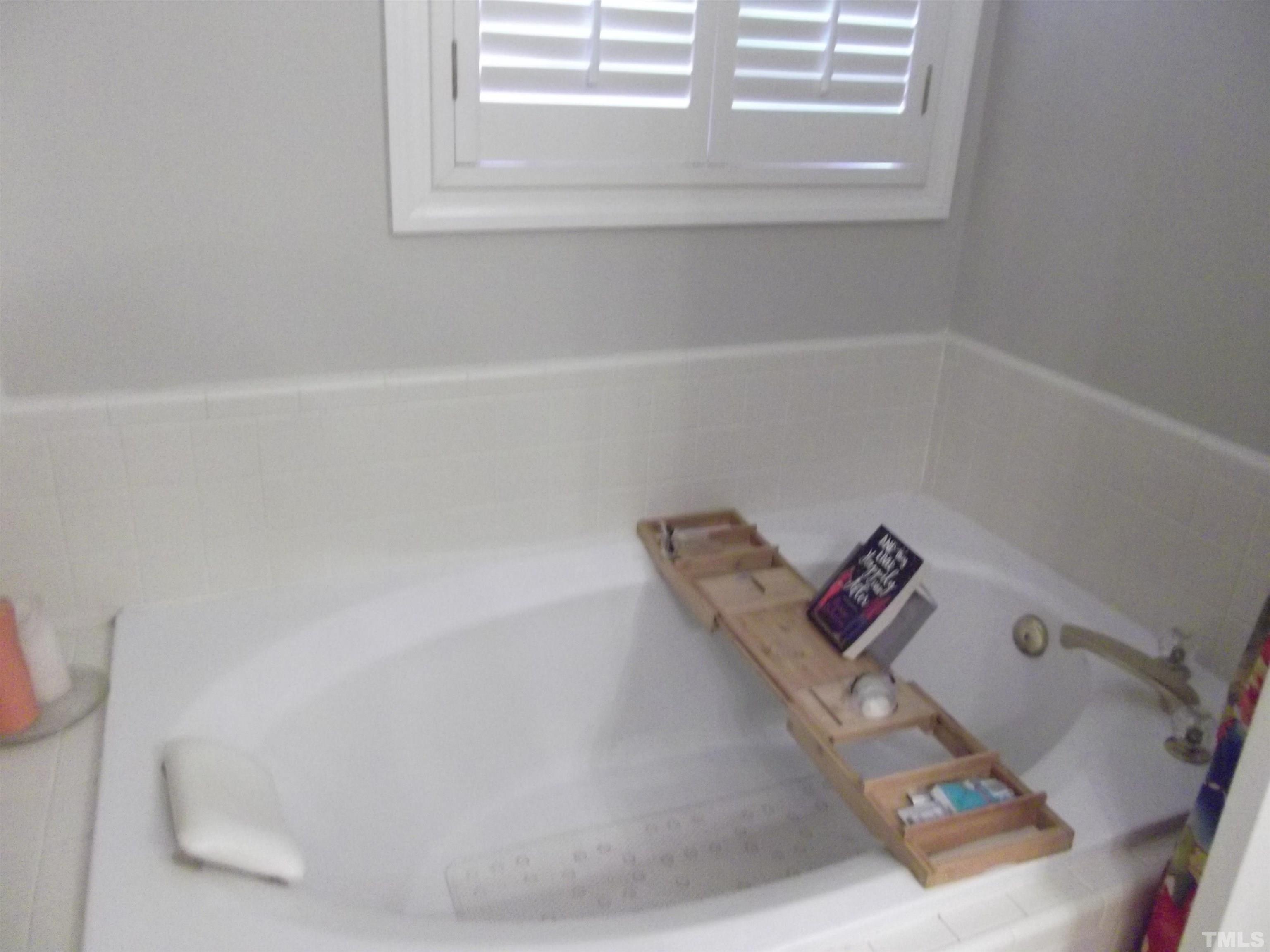 7912 Milltrace Run Raleigh, NC 27615 - Photo 26 of 36 a white bath tub sitting in a bathroom