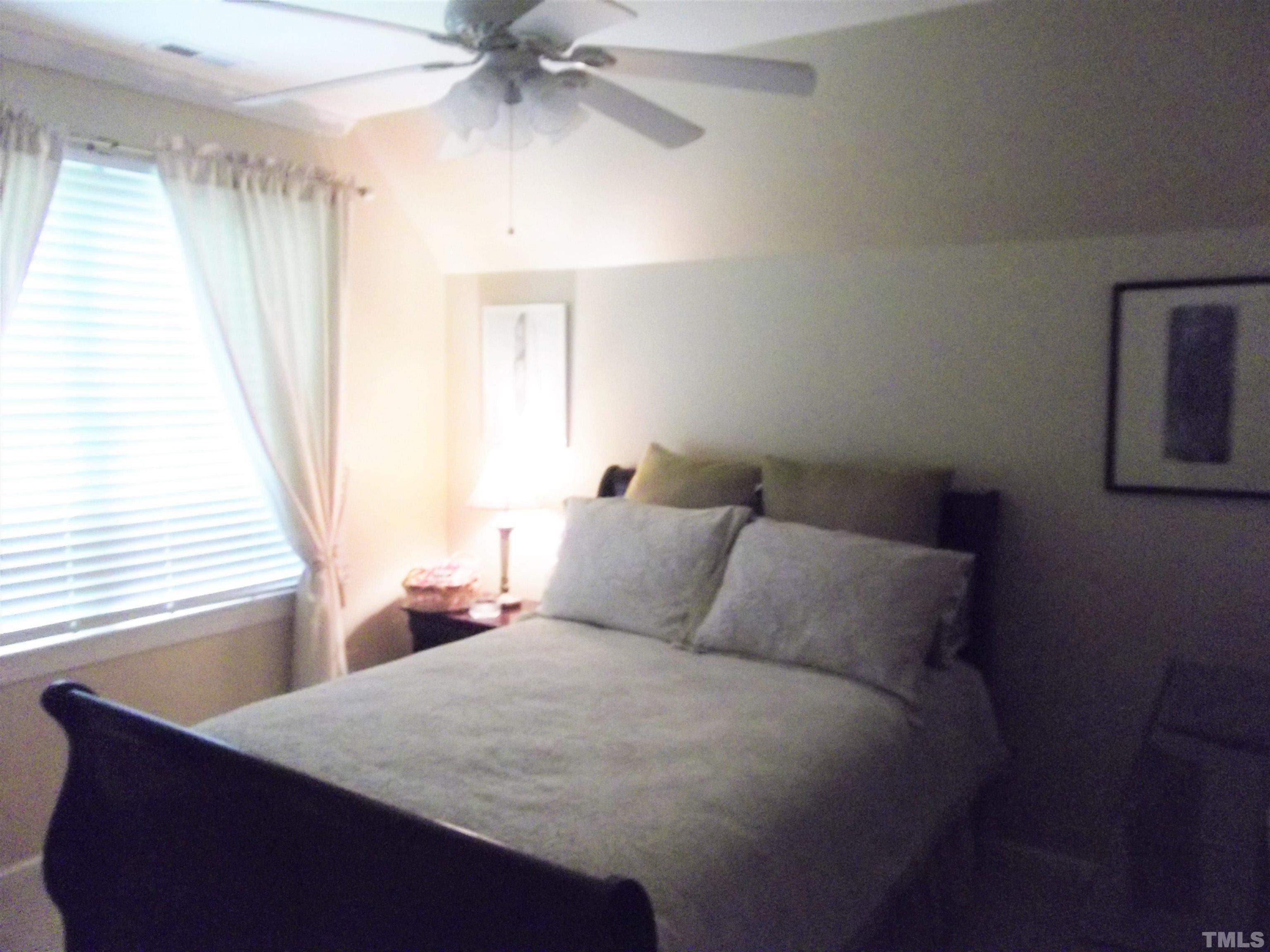 7912 Milltrace Run Raleigh, NC 27615 - Photo 31 of 36 a bedroom with a bed and window