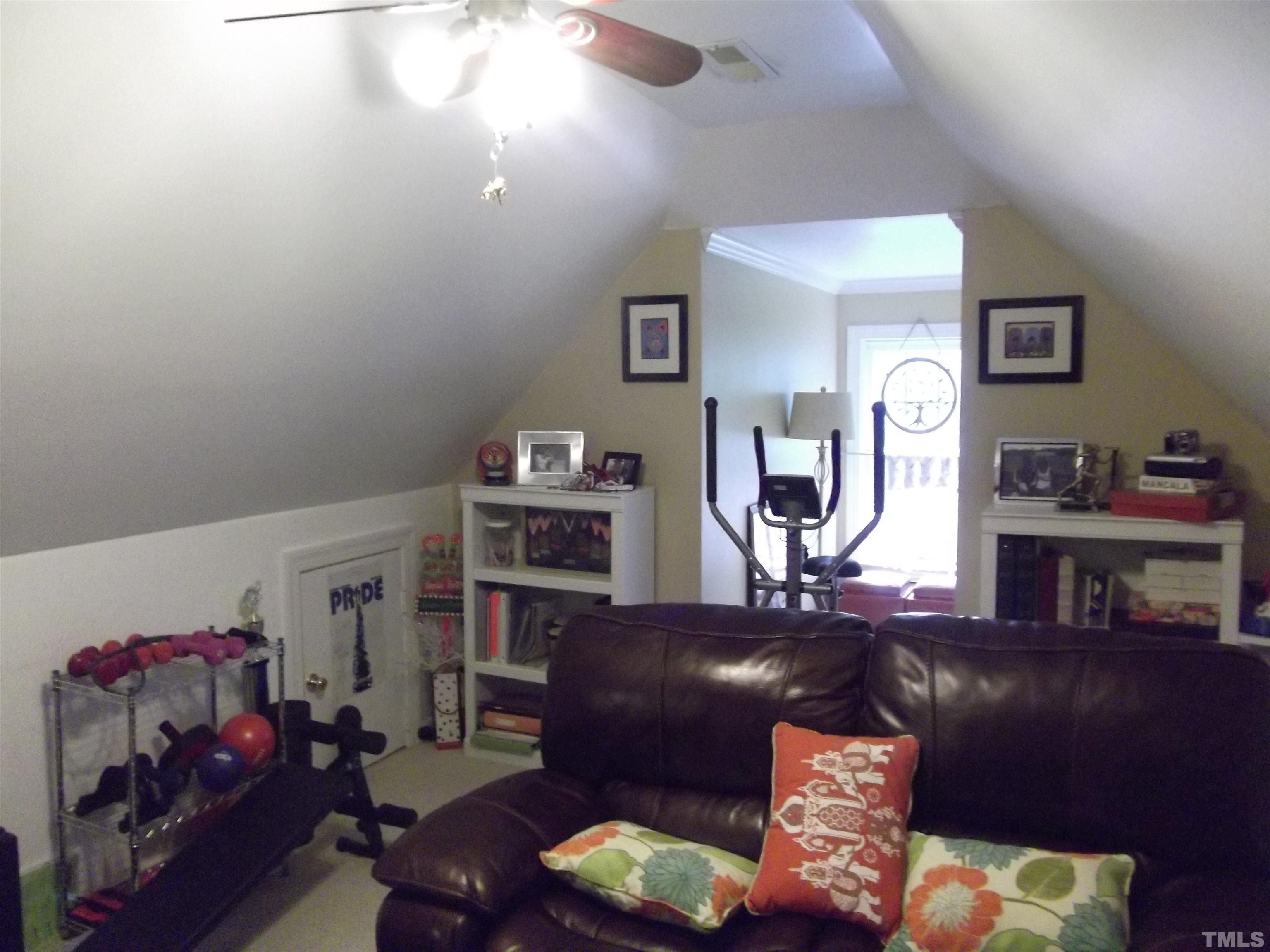 7912 Milltrace Run Raleigh, NC 27615 - Photo 33 of 36 a living room with furniture and a wooden floor