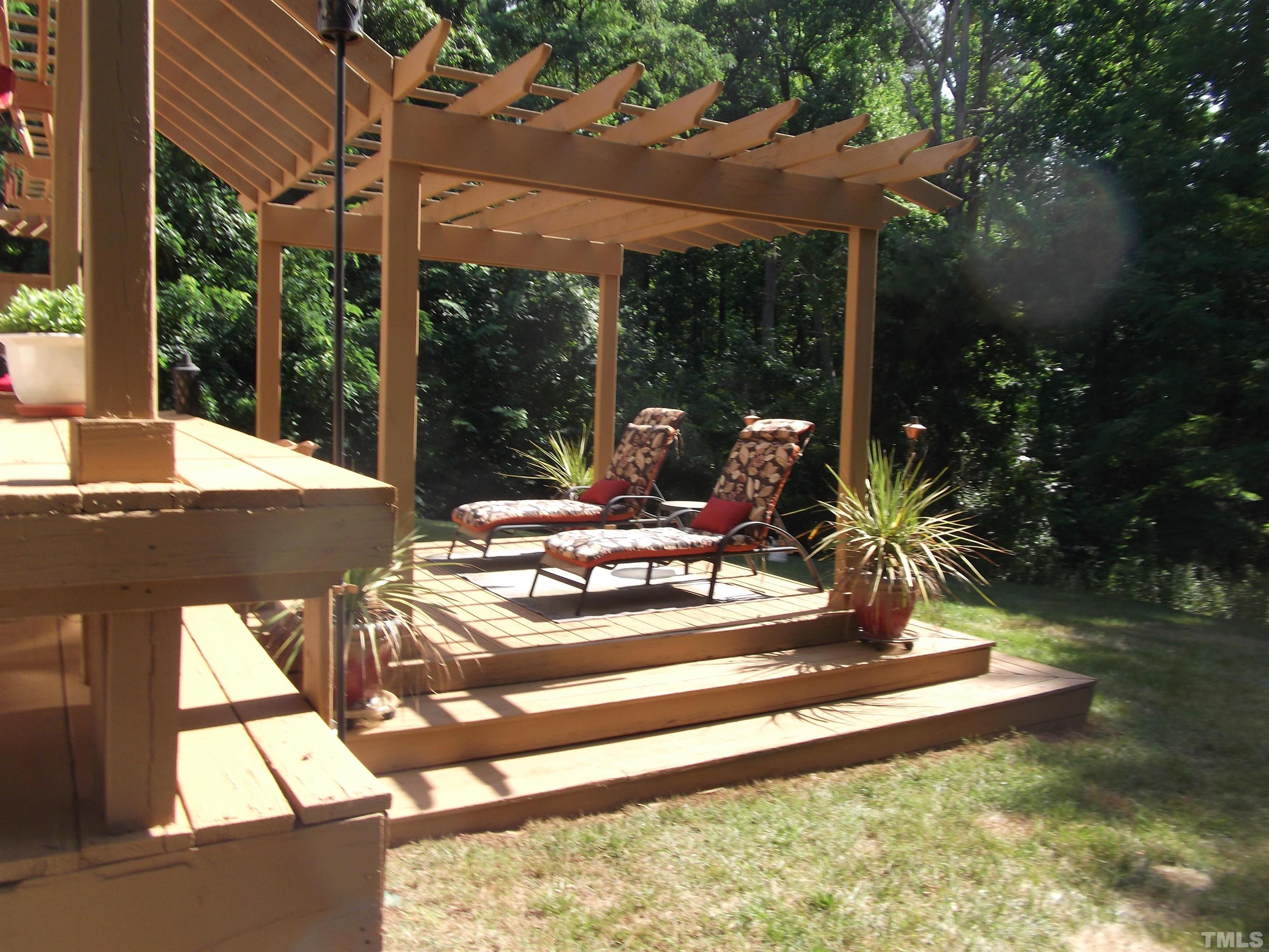 7912 Milltrace Run Raleigh, NC 27615 - Photo 36 of 36 a view of a patio with table and chairs and floor to ceiling window
