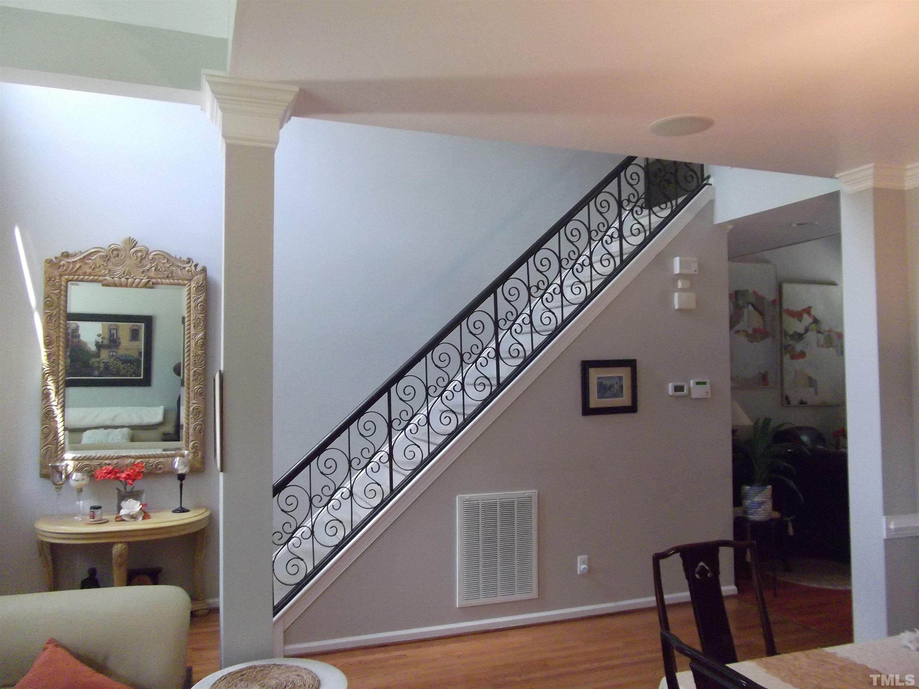 7912 Milltrace Run Raleigh, NC 27615 - Photo 9 of 36 a view of entryway and hall with wooden floor