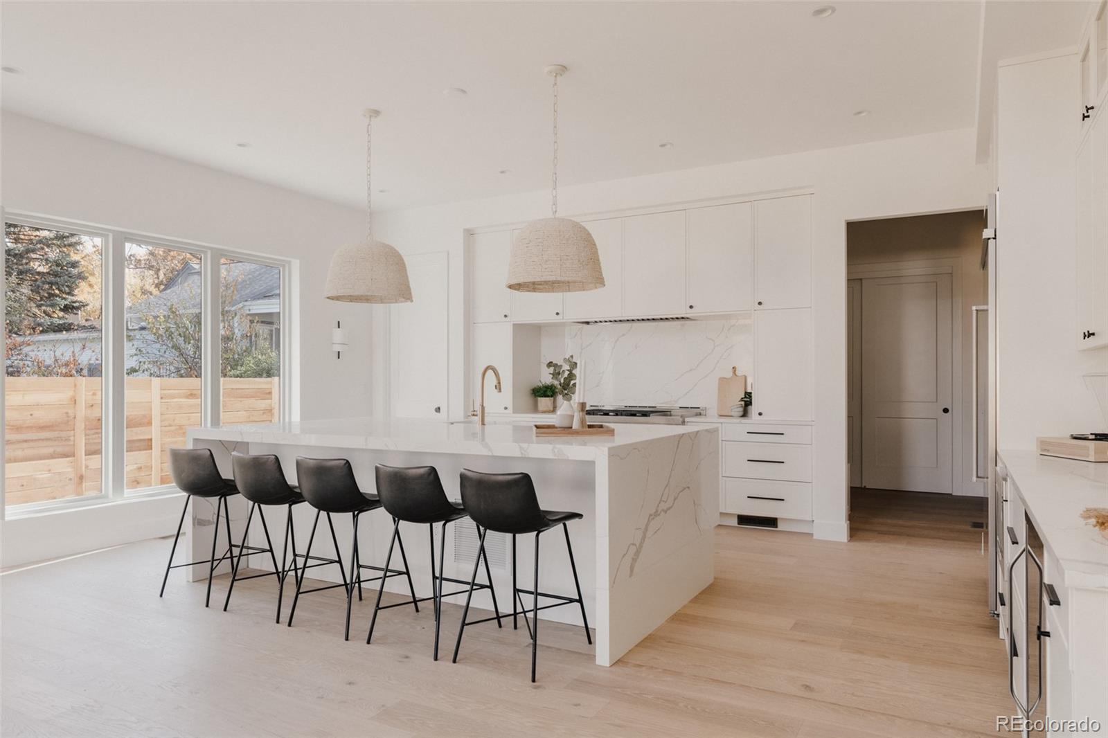 3530 Fenton Street Wheat Ridge, CO 80212 - Photo 12 of 44 a kitchen with a sink and chairs