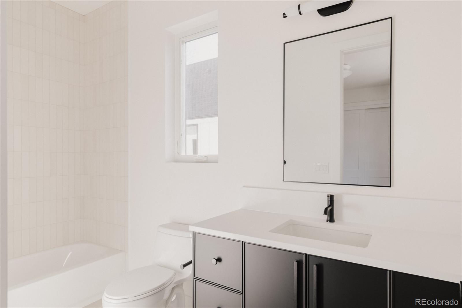 3530 Fenton Street Wheat Ridge, CO 80212 - Photo 29 of 44 a bathroom with a sink a toilet and shower