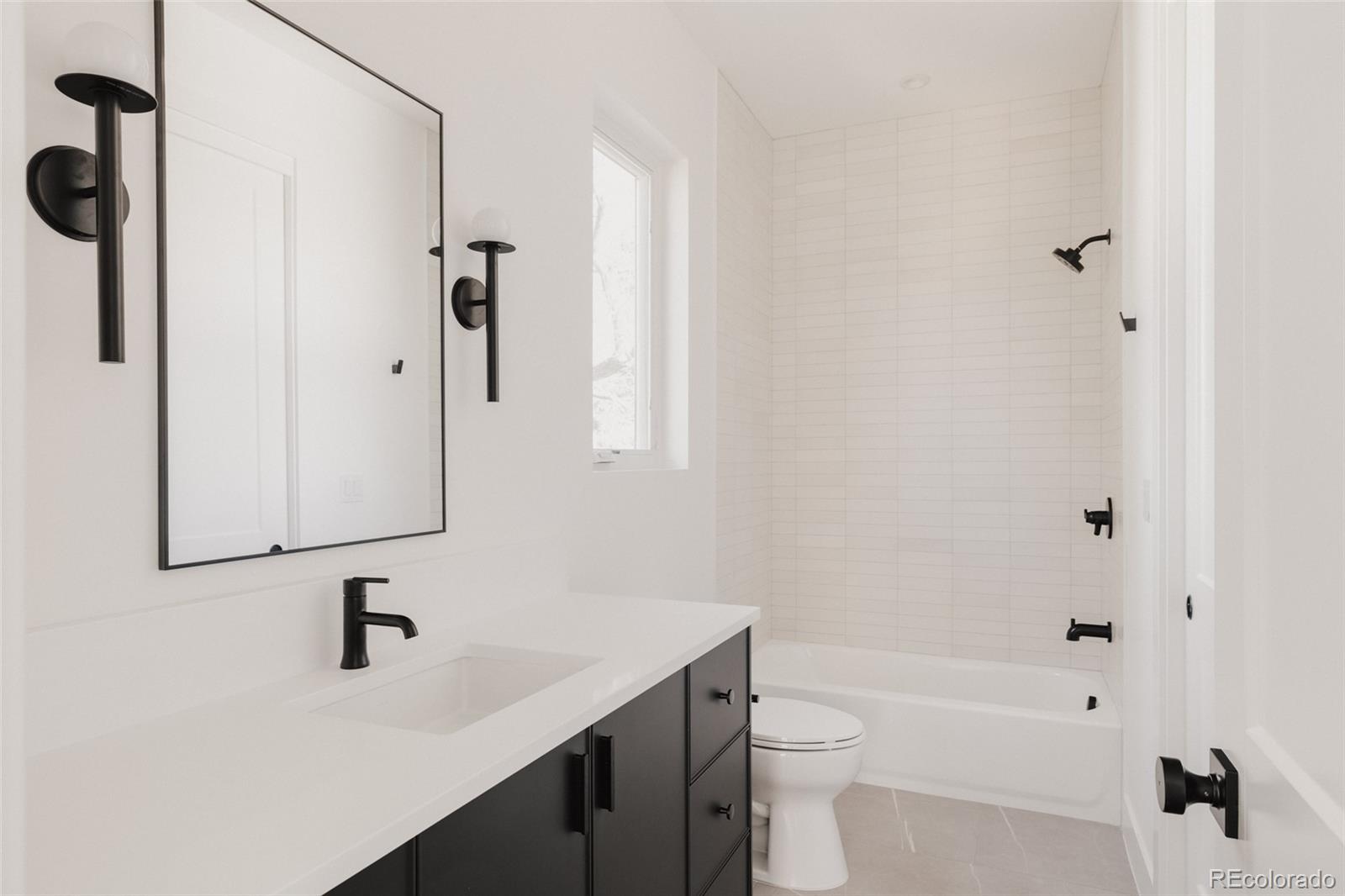 3530 Fenton Street Wheat Ridge, CO 80212 - Photo 30 of 44 a bathroom with a sink a toilet and shower