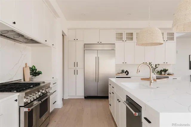 a kitchen with sink a stove and cabinets
