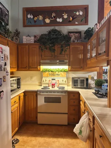 a kitchen with kitchen island granite countertop a stove and a sink
