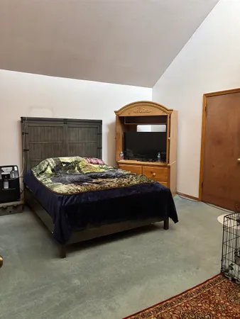 a bedroom with a bed and window