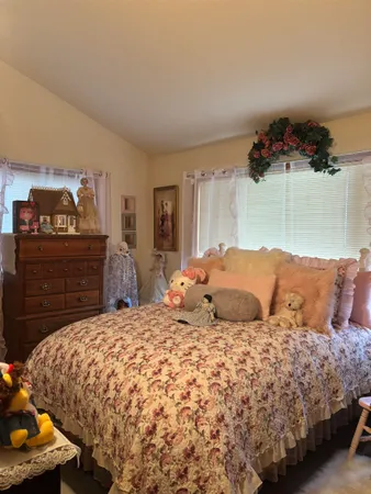 a bedroom with a bed and a television