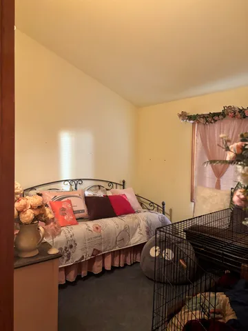 a bedroom with bed and a night stand