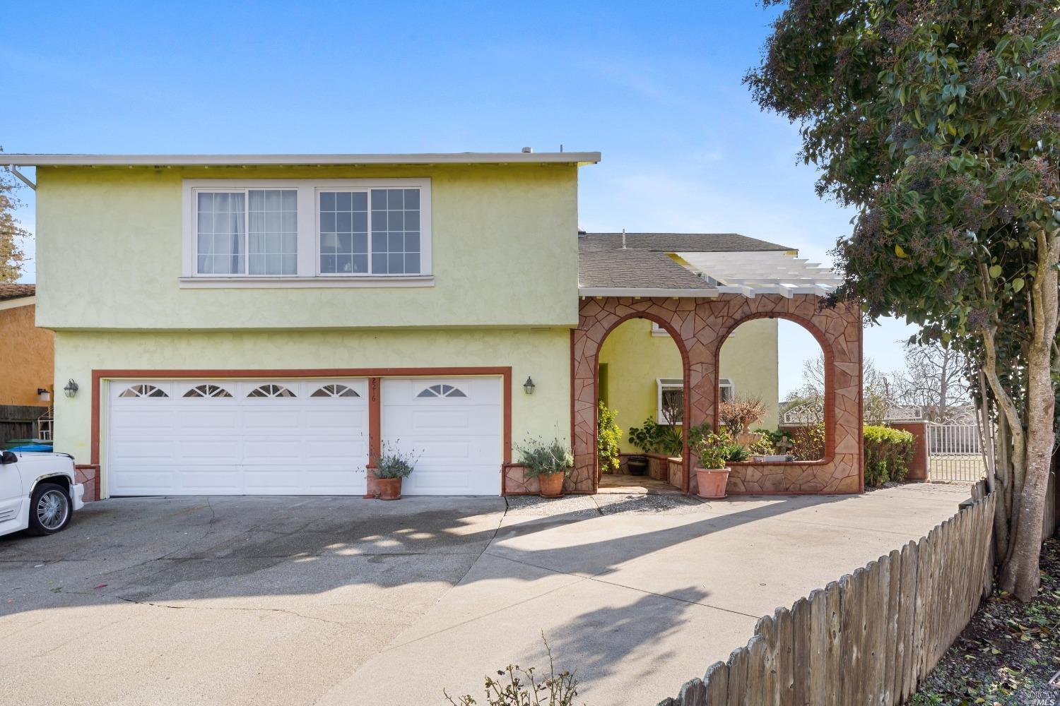 a view of a brick house with a parking area